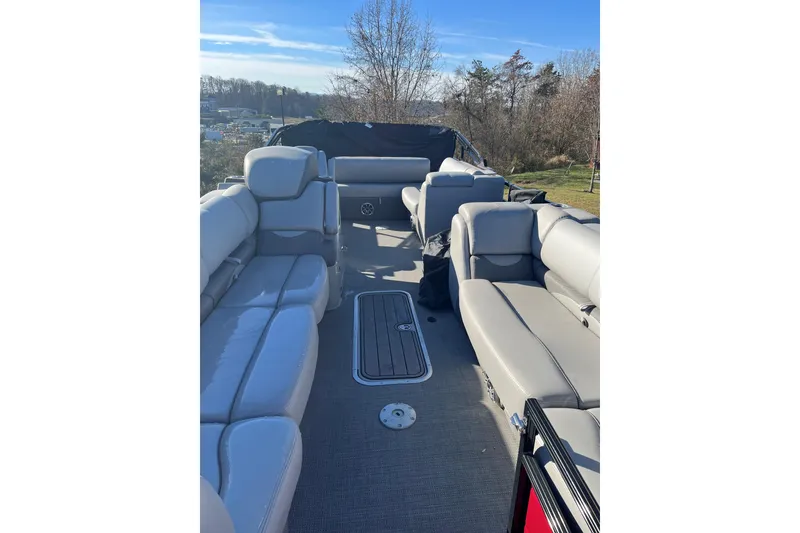 Slide: The Image of 2023 Regency 250DL3 pontoon boat interior with plush seating and spacious layout. - 10
