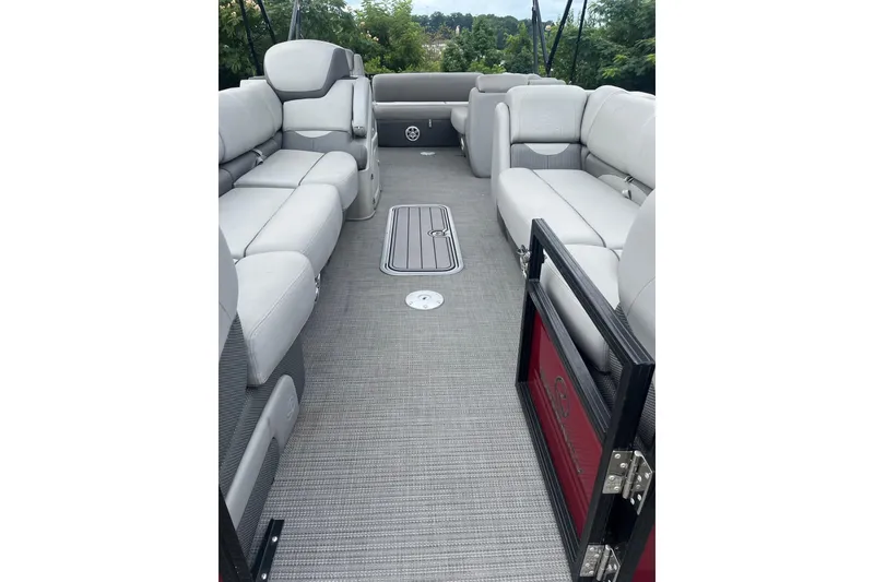 Slide: The Image of 2023 Regency 250DL3 pontoon boat interior with plush seating and spacious layout. - 5