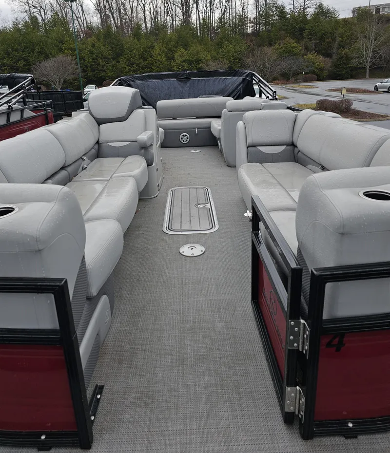 Slide: The Image of 2023 Regency 250DL3: Spacious pontoon boat with gray cushioned seating and ample passenger space. - 3