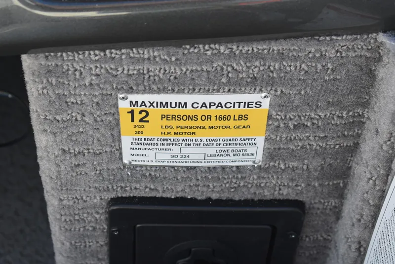 Slide: The Image of 2025 Lowe SD224 Sport Deck capacity label, 12 persons or 1660 lbs, compliance details. - 11