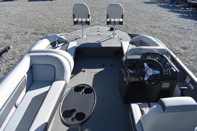 Slide: The Image of 2025 Lowe SD224 Sport Deck boat interior with seating, steering console, and cup holders. - 7