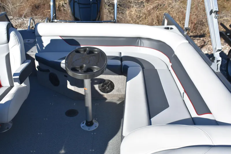 Slide: The Image of 2025 Lowe SD224 Sport Deck boat interior with gray seating and cup holder table. - 8