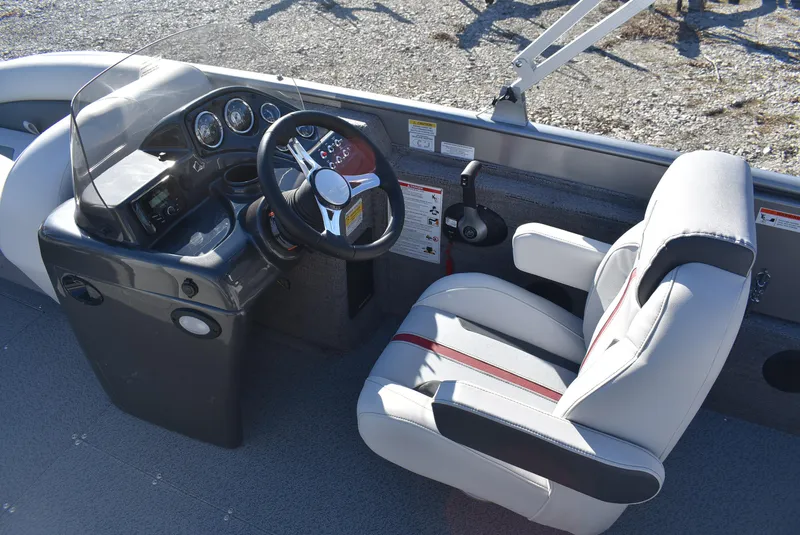 Slide: The Image of 2025 Lowe SD224 Sport Deck boat interior with steering wheel and captain's chair. - 9