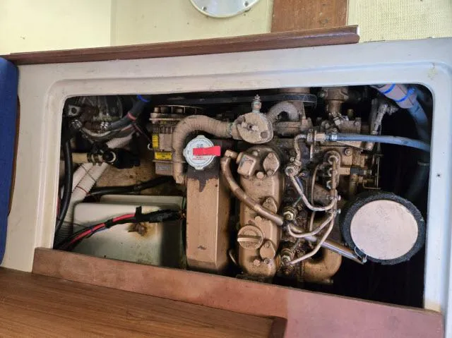 Slide: The Image of Engine compartment of a 1983 Catalina 30 sailboat, showcasing mechanical components. - 17