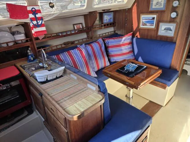 Slide: The Image of Interior of 1983 Catalina 30 sailboat with cozy seating and nautical decor. - 2
