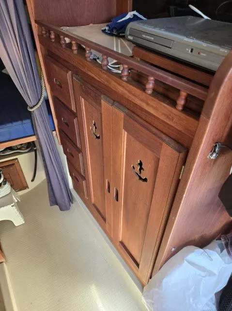 Slide: The Image of Interior of 1983 Catalina 30 sailboat with wooden cabinetry and nautical decor. - 4