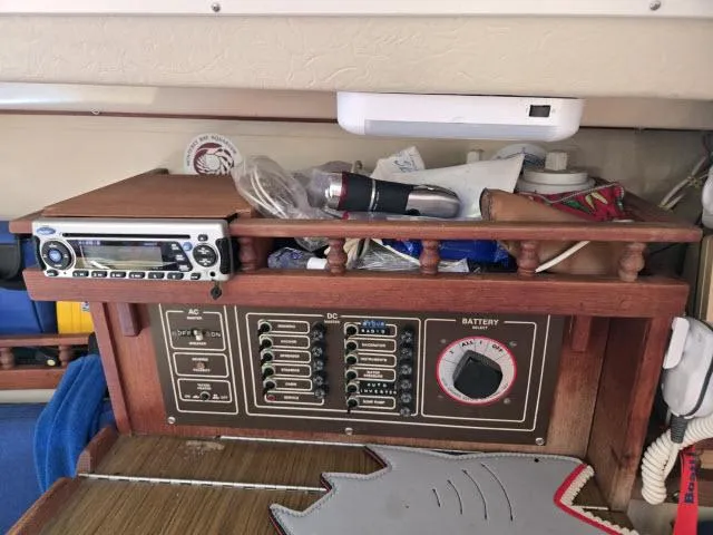 Slide: The Image of Electrical panel of a 1983 Catalina 30 sailboat with radio and storage shelf. - 6
