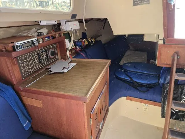 Slide: The Image of Interior of a 1983 Catalina 30 sailboat with navigation station and cozy seating area. - 8