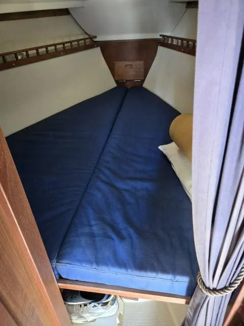 Slide: The Image of Interior cabin of 1983 Catalina 30 sailboat with blue bedding. - 9