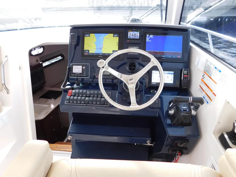 Slide: The Image of 2018 Pursuit OS 325 Offshore helm with advanced navigation displays and controls. - 12