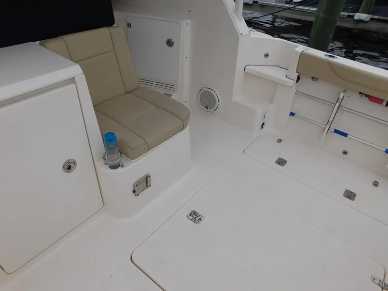 Slide: The Image of 2018 Pursuit OS 325 Offshore boat interior with seating and storage compartments. - 26