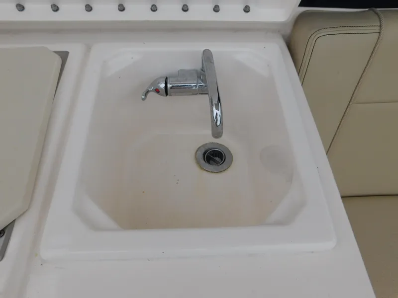 Slide: The Image of 2018 Pursuit OS 325 Offshore boat sink with chrome faucet. - 29