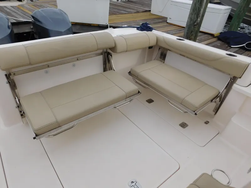 Slide: The Image of 2018 Pursuit OS 325 Offshore boat with beige foldable seating in the cockpit area. - 34