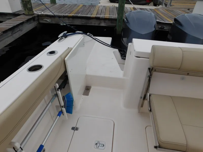 Slide: The Image of 2018 Pursuit OS 325 Offshore boat interior with seating and storage compartments. - 35