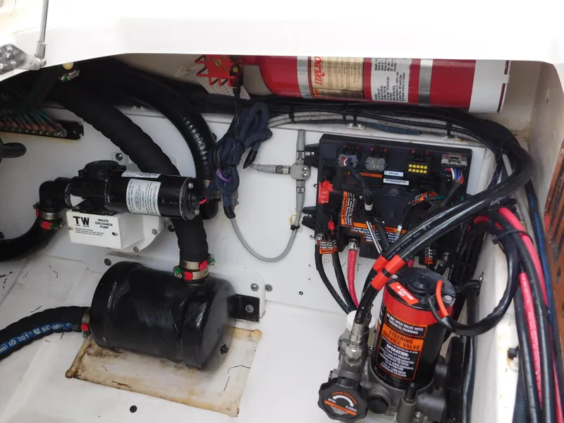 Slide: The Image of Engine compartment of 2018 Pursuit OS 325 Offshore with wiring and fire extinguisher. - 41