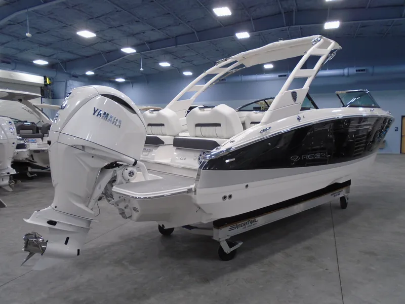 Slide: The Image of 2025 Regal LX6 boat with Yamaha engine in showroom setting. - 21