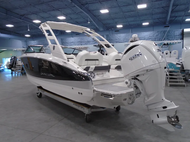 Slide: The Image of 2025 Regal LX6 boat with Yamaha engine displayed indoors. - 23