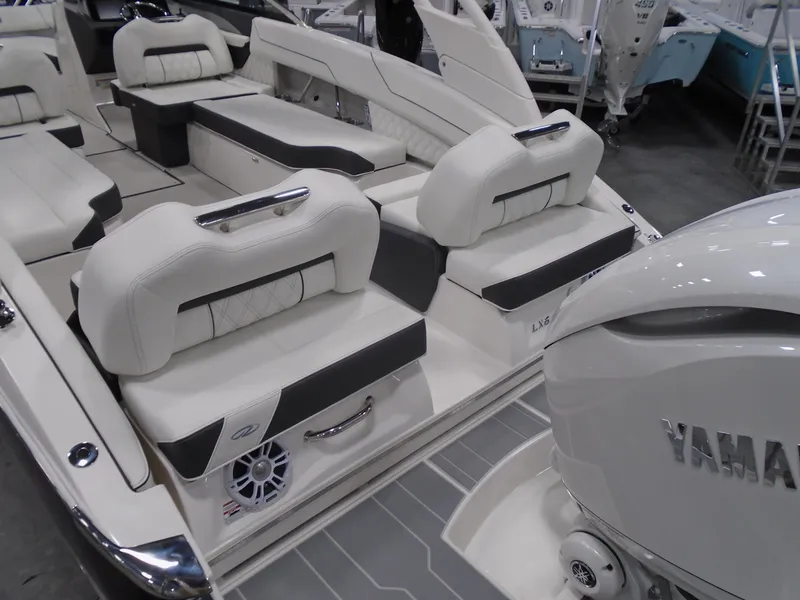 Slide: The Image of 2025 Regal LX6 boat interior with Yamaha engine, featuring luxurious white seating and modern design. - 24