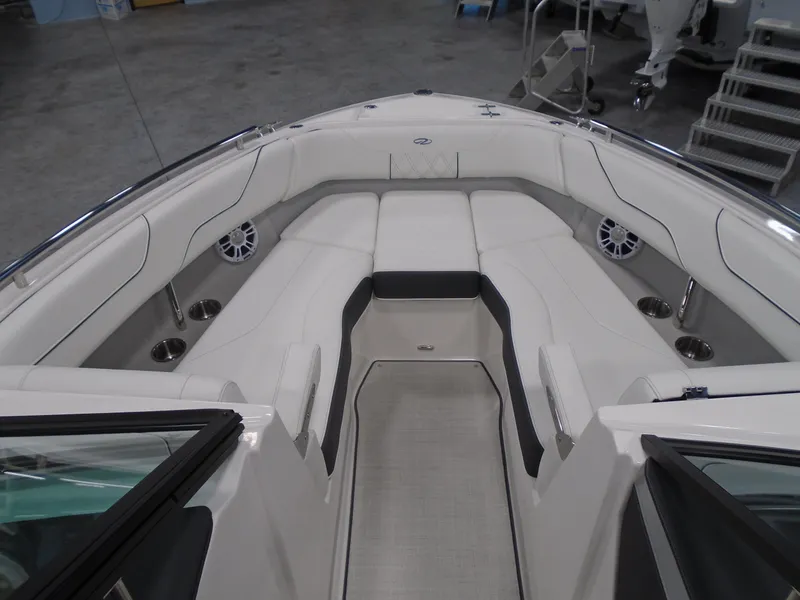Slide: The Image of 2025 Regal LX6 boat interior with white seating and stainless steel cup holders. - 29