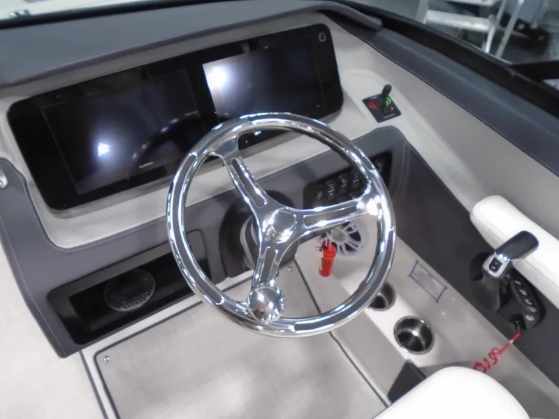 Slide: The Image of 2025 Regal LX6 boat dashboard with modern steering wheel and dual displays. - 31