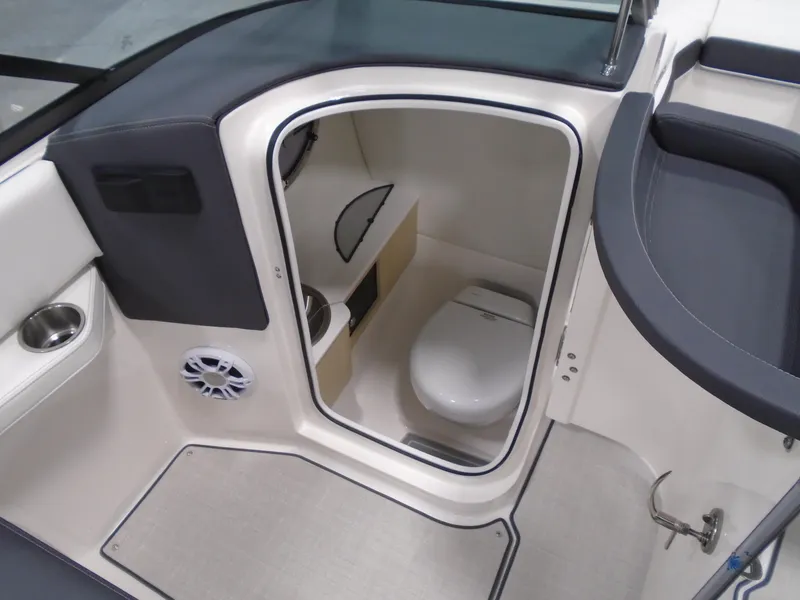 Slide: The Image of 2025 Regal LX6 boat interior with compact bathroom and modern amenities. - 32