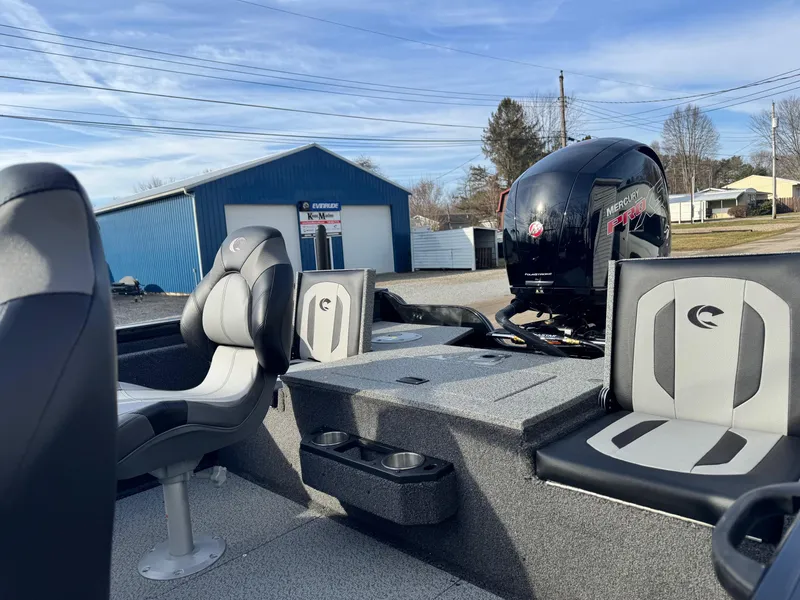 Slide: The Image of 2025 Crestliner 1850 Fish Hawk WT JS boat interior with Mercury engine, parked outdoors. - 8