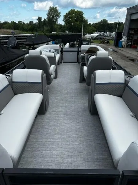 Slide: The Image of 2024 Qwest E824 RLS LTZ pontoon boat on trailer under cloudy sky. - 2