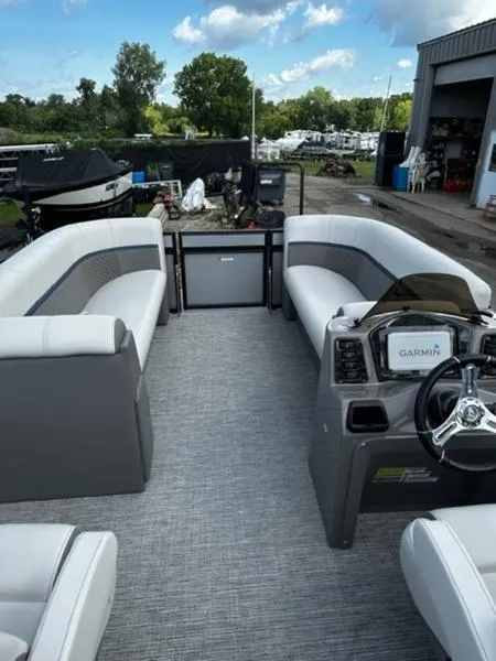 Slide: The Image of 2024 Qwest E824 RLS LTZ boat interior with steering wheel and captain's chair. - 4