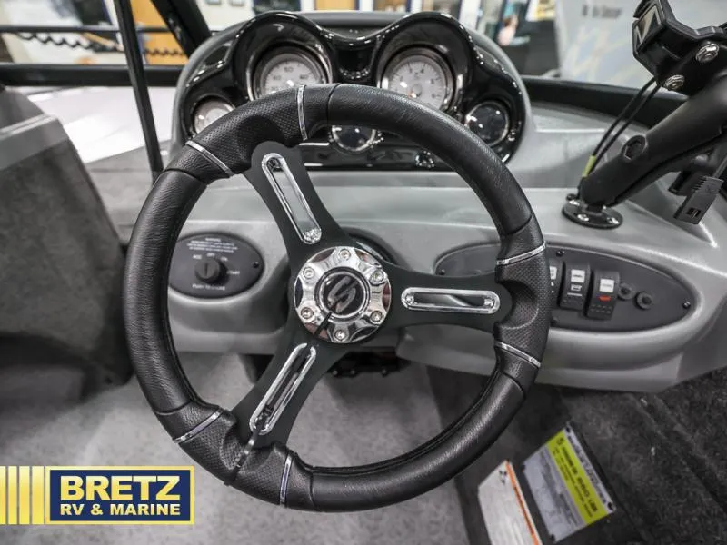 Slide: The Image of 2024 PRO ANGLER 162 boat dashboard with steering wheel and gauges, Bretz RV & Marine logo. - 10