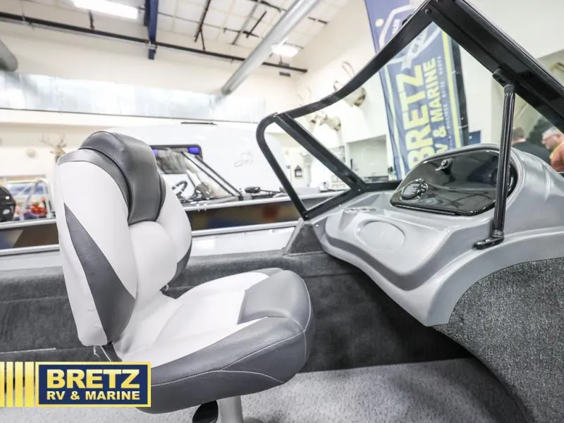 Slide: The Image of 2024 PRO ANGLER 162 boat interior with steering console and cushioned seat at Bretz RV & Marine. - 12
