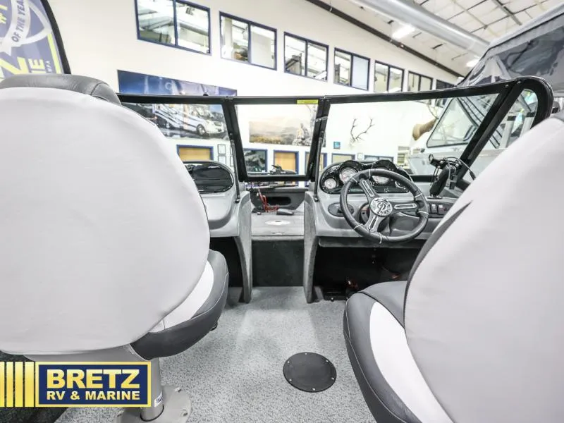 Slide: The Image of 2024 PRO ANGLER 162 boat interior with steering wheel and seats at Bretz RV & Marine showroom. - 15
