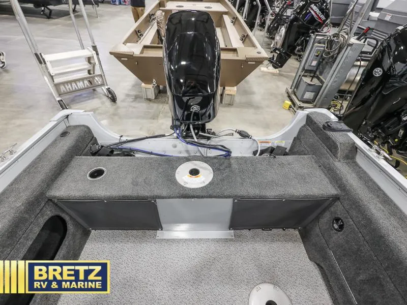 Slide: The Image of 2024 PRO ANGLER 162 boat interior with motor, displayed at Bretz RV & Marine showroom. - 19