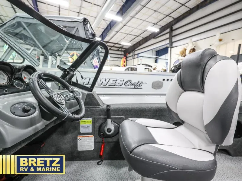 Slide: The Image of 2024 PRO ANGLER 162 boat interior with steering wheel and seat at Bretz RV & Marine showroom. - 9