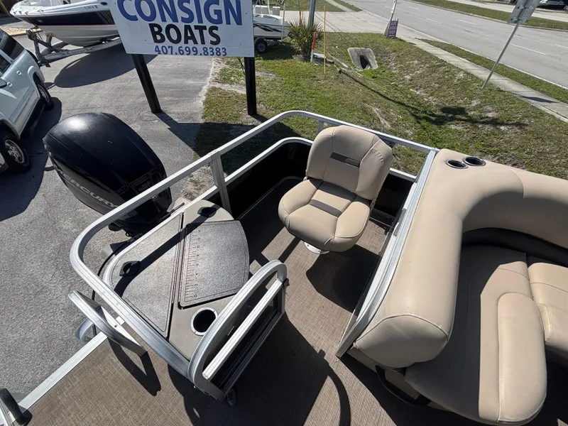 Slide: The Image of 2020 Sun Tracker Bass Buggy 18 DLX pontoon boat interior with seating and console. - 10