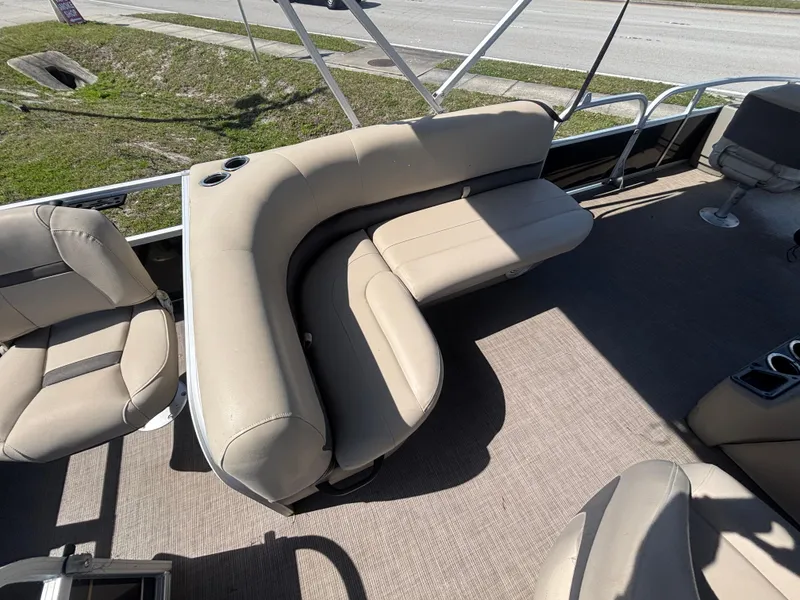 Slide: The Image of 2020 Sun Tracker Bass Buggy 18 DLX pontoon boat with beige seating and cup holders. - 13
