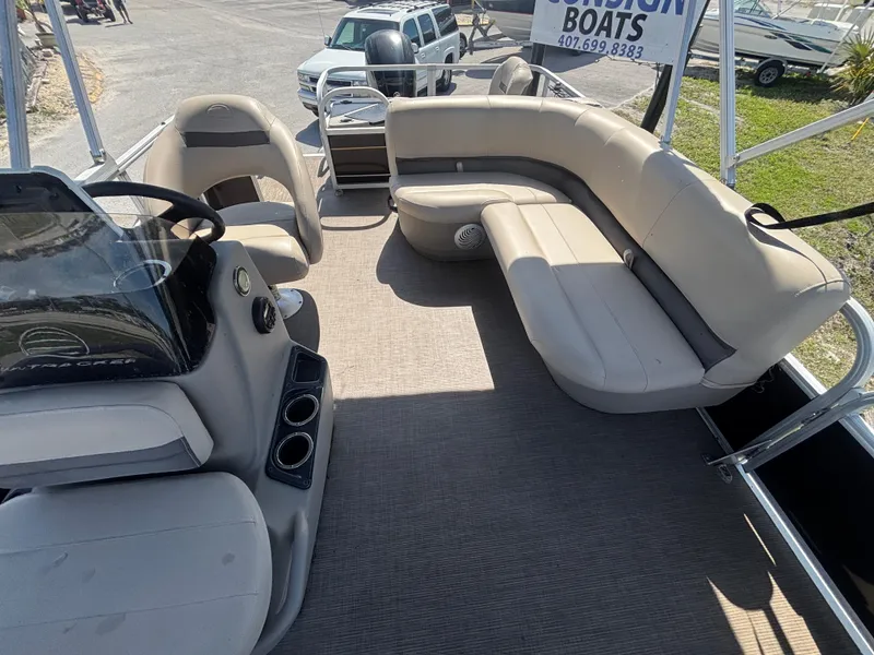 Slide: The Image of 2020 Sun Tracker Bass Buggy 18 DLX pontoon boat interior with spacious seating and steering console. - 17