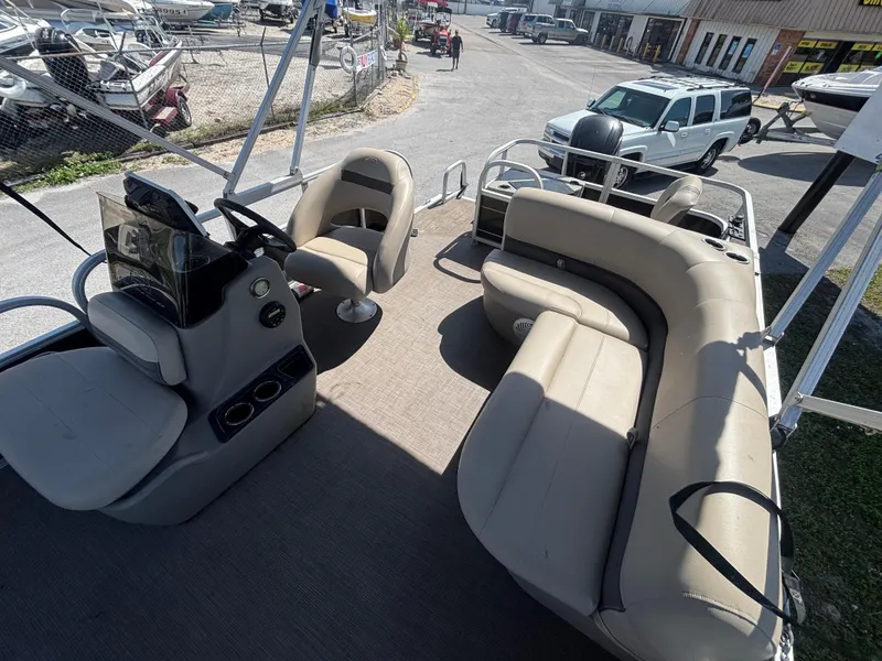 Slide: The Image of 2020 Sun Tracker Bass Buggy 18 DLX pontoon boat interior with seating and steering console. - 18