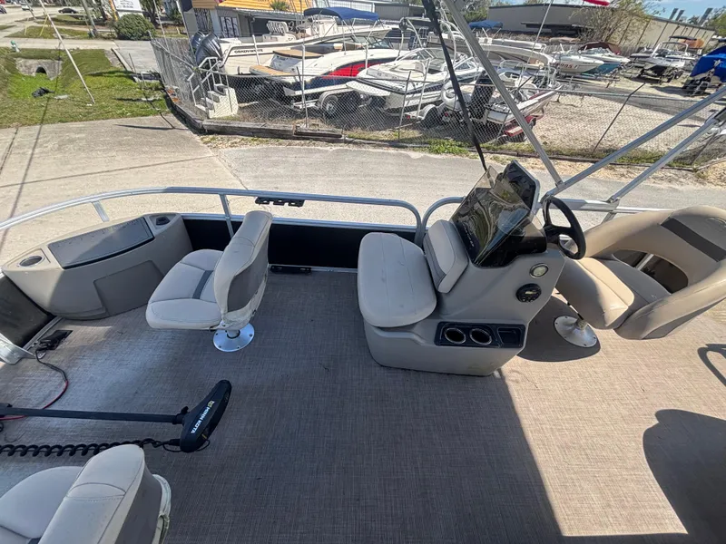 Slide: The Image of 2020 Sun Tracker Bass Buggy 18 DLX pontoon boat interior with seating and steering console. - 19