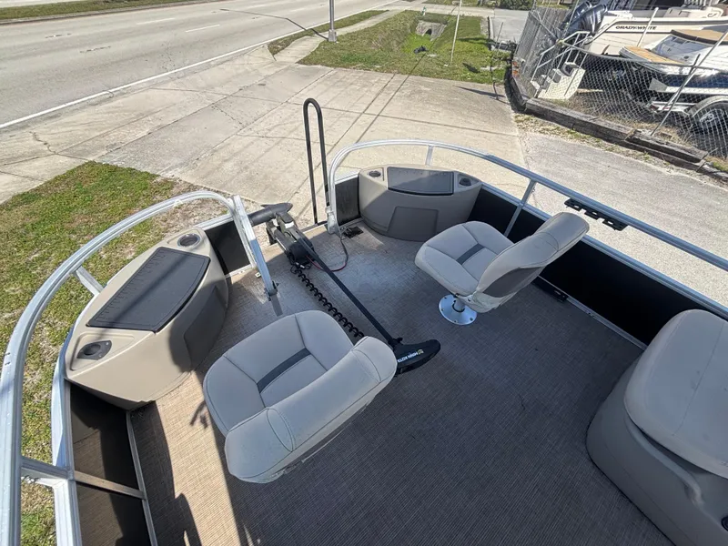 Slide: The Image of 2020 Sun Tracker Bass Buggy 18 DLX pontoon boat interior with seating and steering. - 20