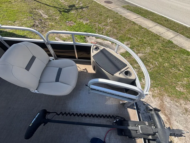 Slide: The Image of 2020 Sun Tracker Bass Buggy 18 DLX pontoon boat interior with seating and controls. - 23