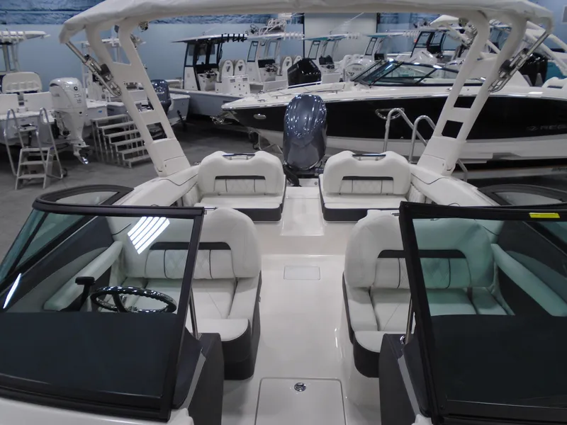 Slide: The Image of 2025 Regal LX2 boat interior with seating, showcased in a showroom. - 10