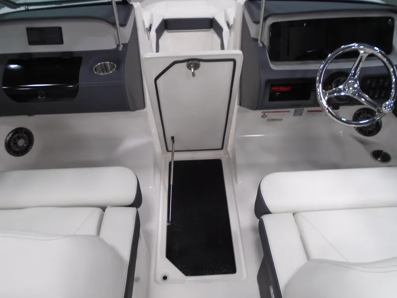 Slide: The Image of Interior of 2025 Regal LX2 boat with white seating and modern dashboard. - 11
