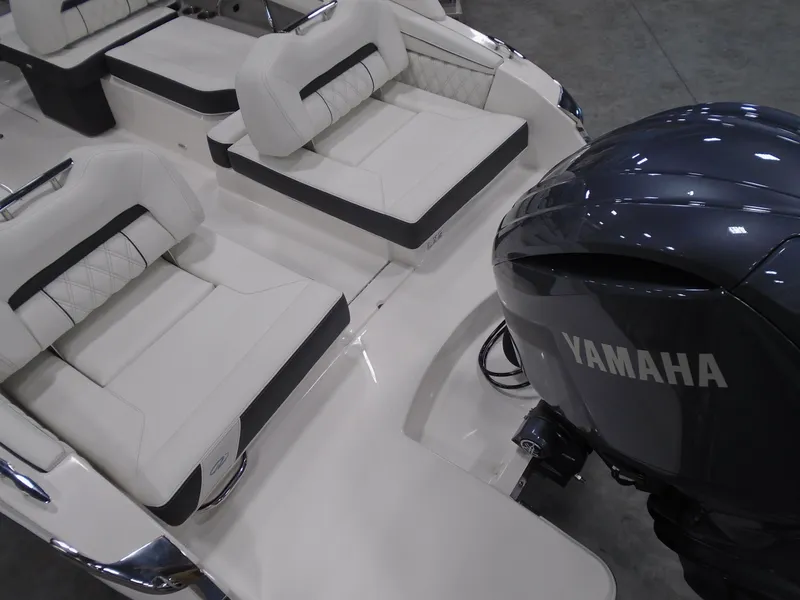 Slide: The Image of 2025 Regal LX2 boat interior with Yamaha engine, featuring white cushioned seating. - 5