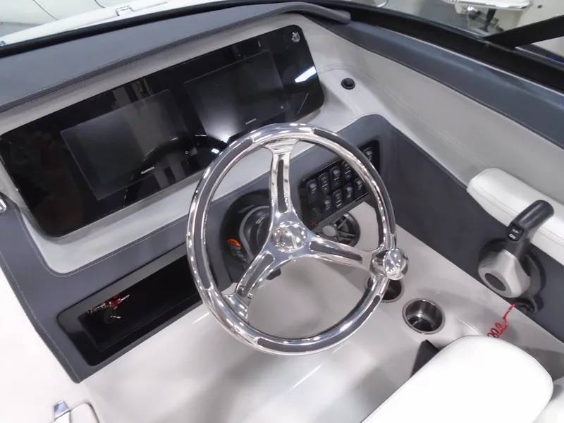 Slide: The Image of 2025 Regal LX2 boat dashboard with modern steering wheel and control panel. - 7