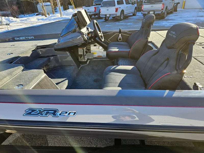 Slide: The Image of 2025 Skeeter ZXR20 boat interior with dual seats and steering console. - 4