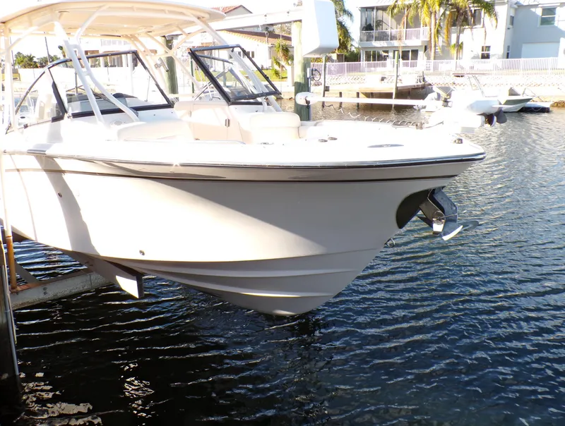 Slide: The Image of 2016 Grady-White Freedom 275 boat docked in a sunny marina setting. - 11