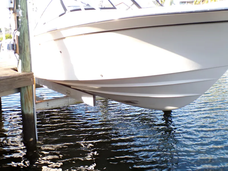 Slide: The Image of 2016 Grady-White Freedom 275 boat on lift above water. - 12