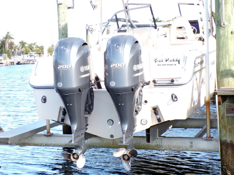 Slide: The Image of 2016 Grady-White Freedom 275 with twin Yamaha 200 engines docked by the water. - 16