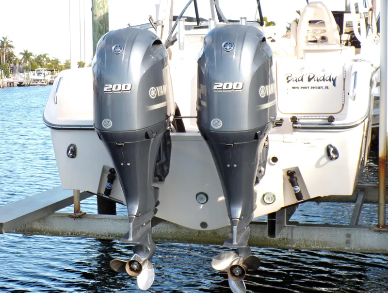 Slide: The Image of 2016 Grady-White Freedom 275 with twin Yamaha 200 engines on a boat lift. - 17