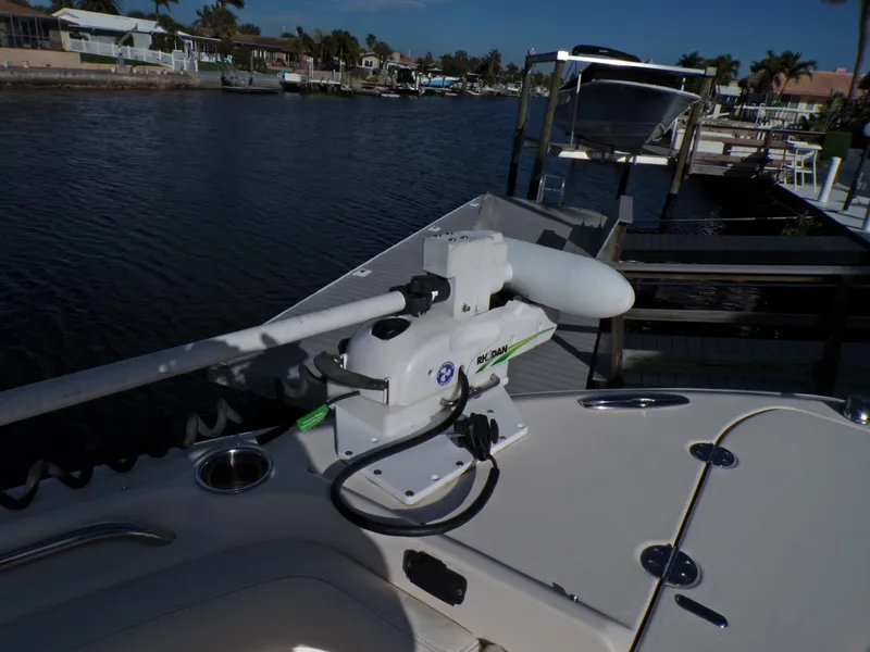 Slide: The Image of 2016 Grady-White Freedom 275 boat with trolling motor docked by waterfront homes. - 19